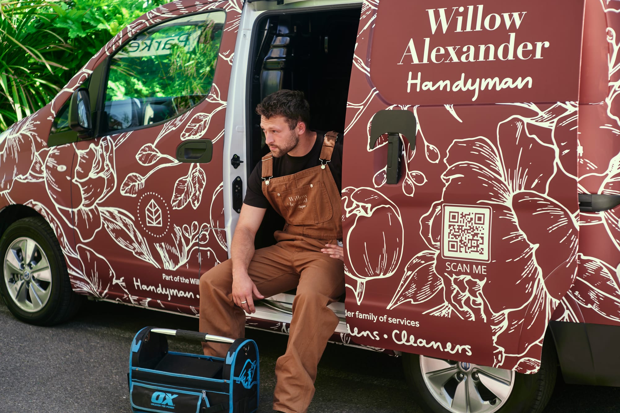 Willow Alexander driver with the side doors of a branded van open, ready to load